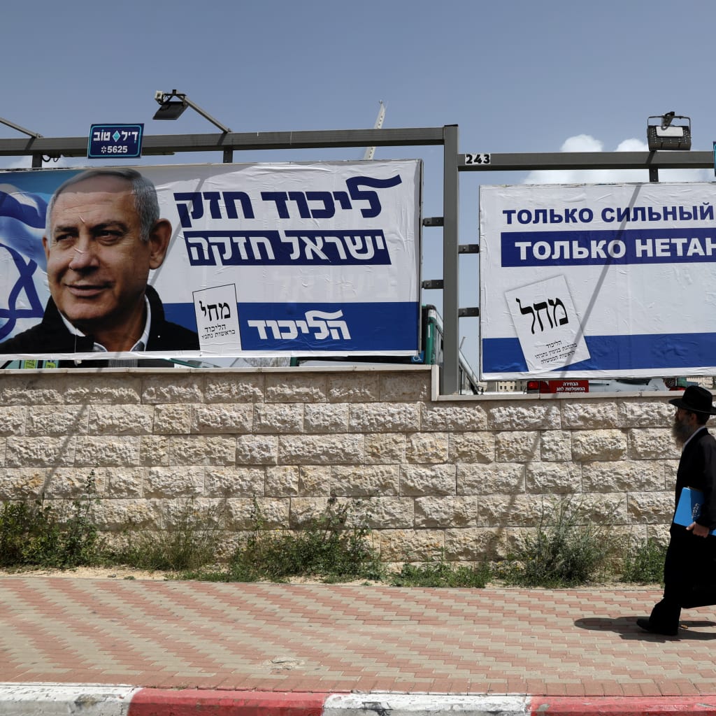 <p>An Orthodox Jewish man walks past an election campaign poster in Jerusalem.</p>
