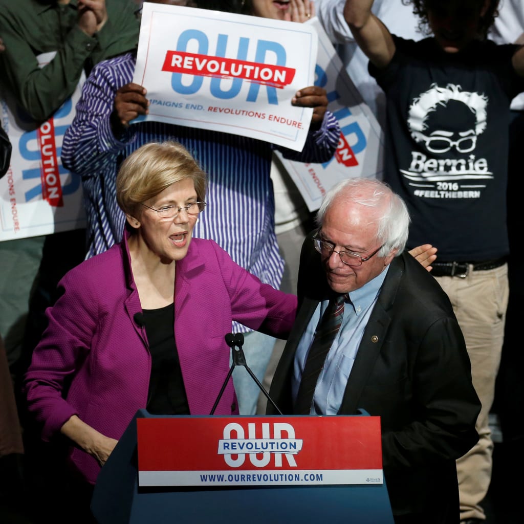 <p>U.S. Senator Elizabeth Warren puts her arm around U.S. Senator Bernie Sanders after introducing him at a rally in Boston, Massachusetts, on March 31, 2017. </p>
