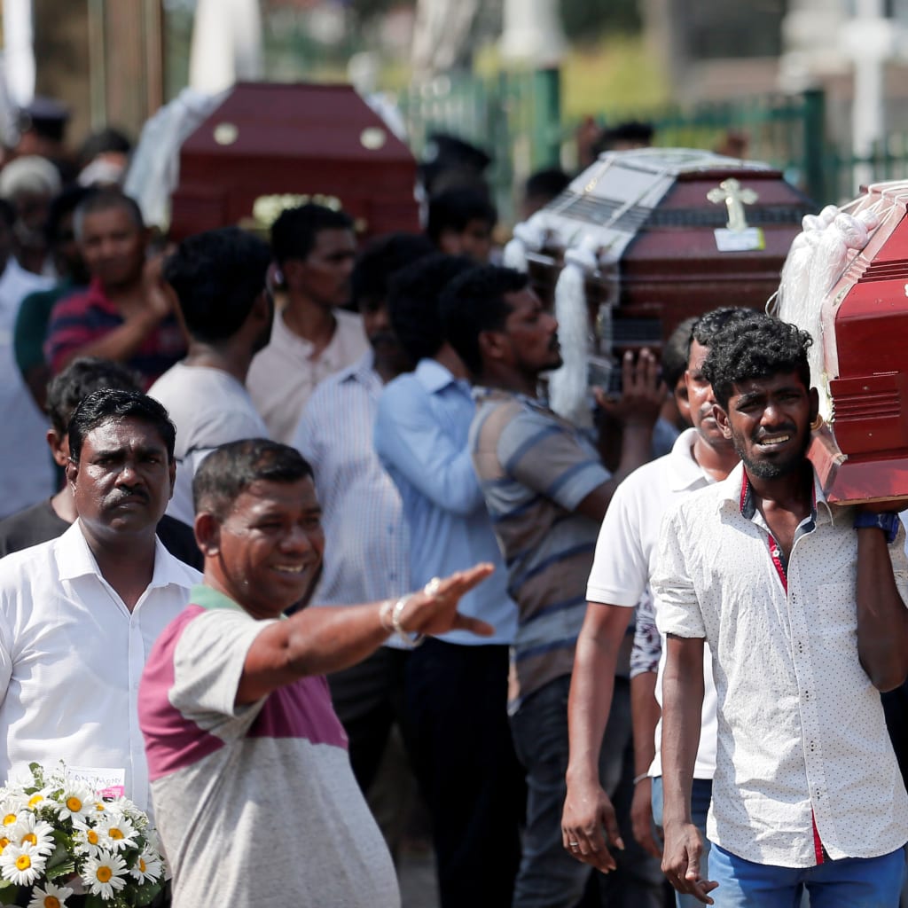 <p>Coffins of victims are carried in Colombo, Sri Lanka.</p>

