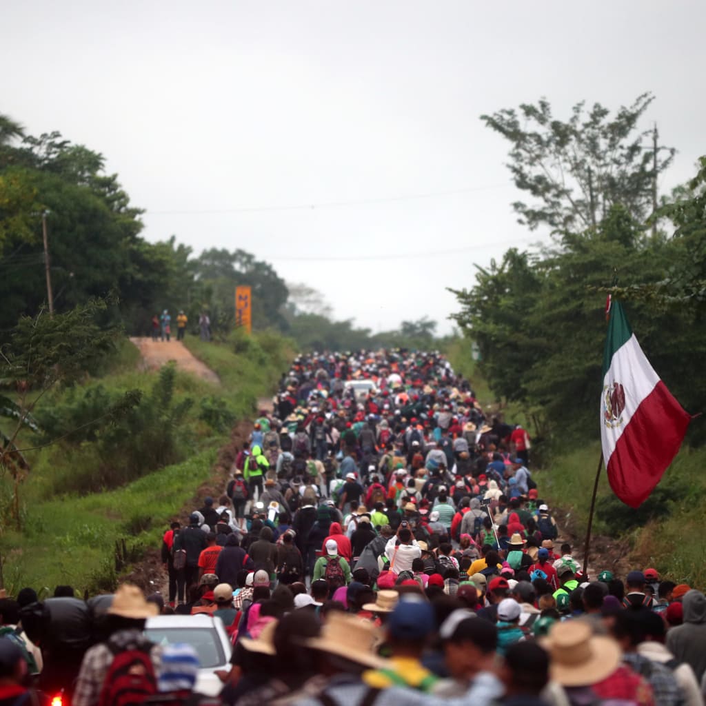 <p>Central Americans en route to the United States walk along a highway in Mexico.</p>
