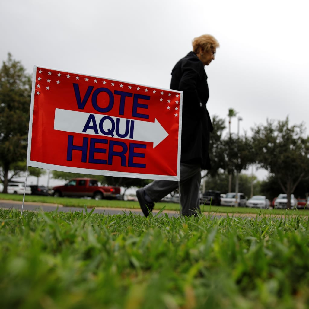 <p>A woman arrives at a polling station as the early voting for midterm elections started in Texas, October 22, 2018. </p>
