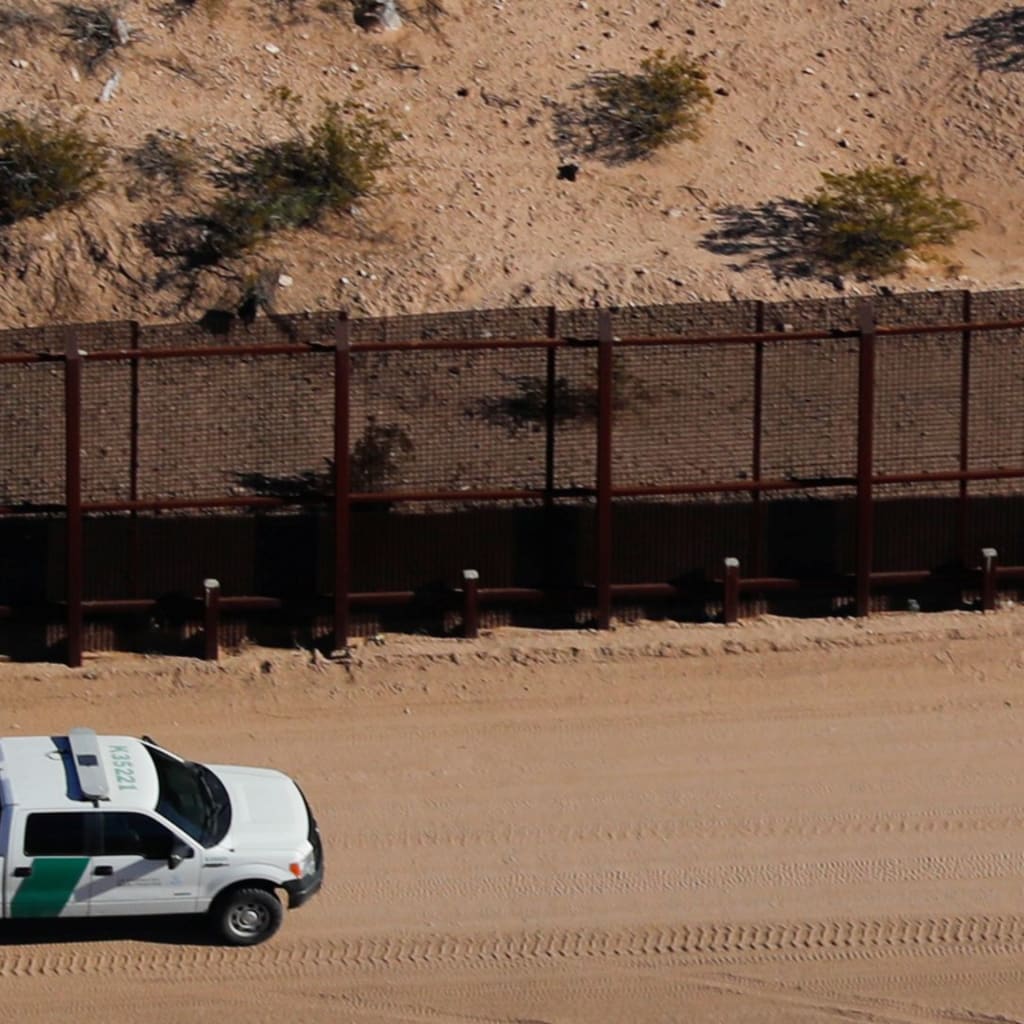 <p>A U.S. border patrol truck drives along the border fence between Mexico and Sunland Park, New Mexico.</p>
