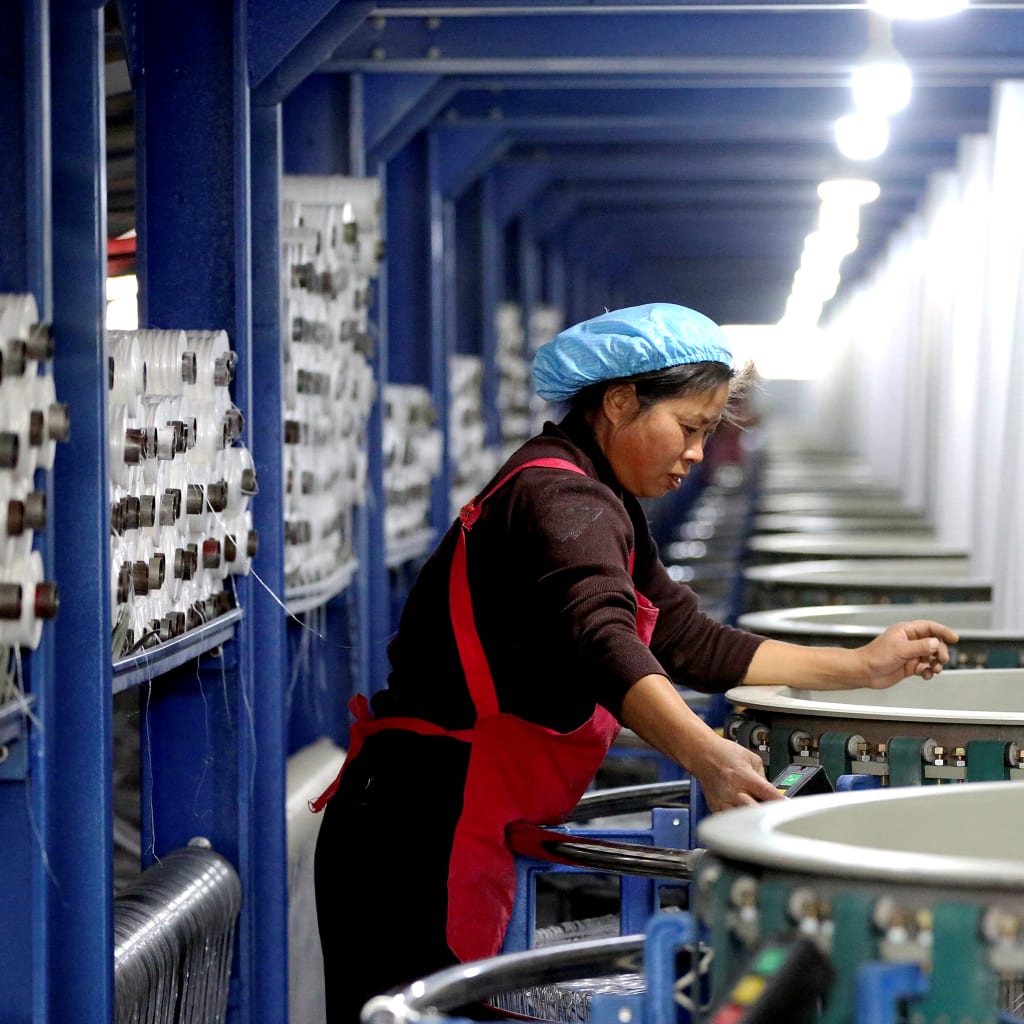 <p>An employee works on the assembly line of a factory manufacturing bags in Huai’an, China.</p>