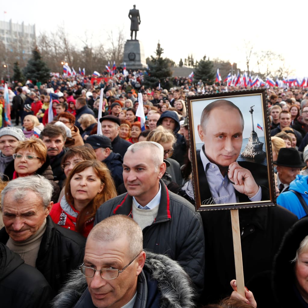 <p>People attend a rally marking the fourth anniversary of Russia’s annexation of Crimea.</p>