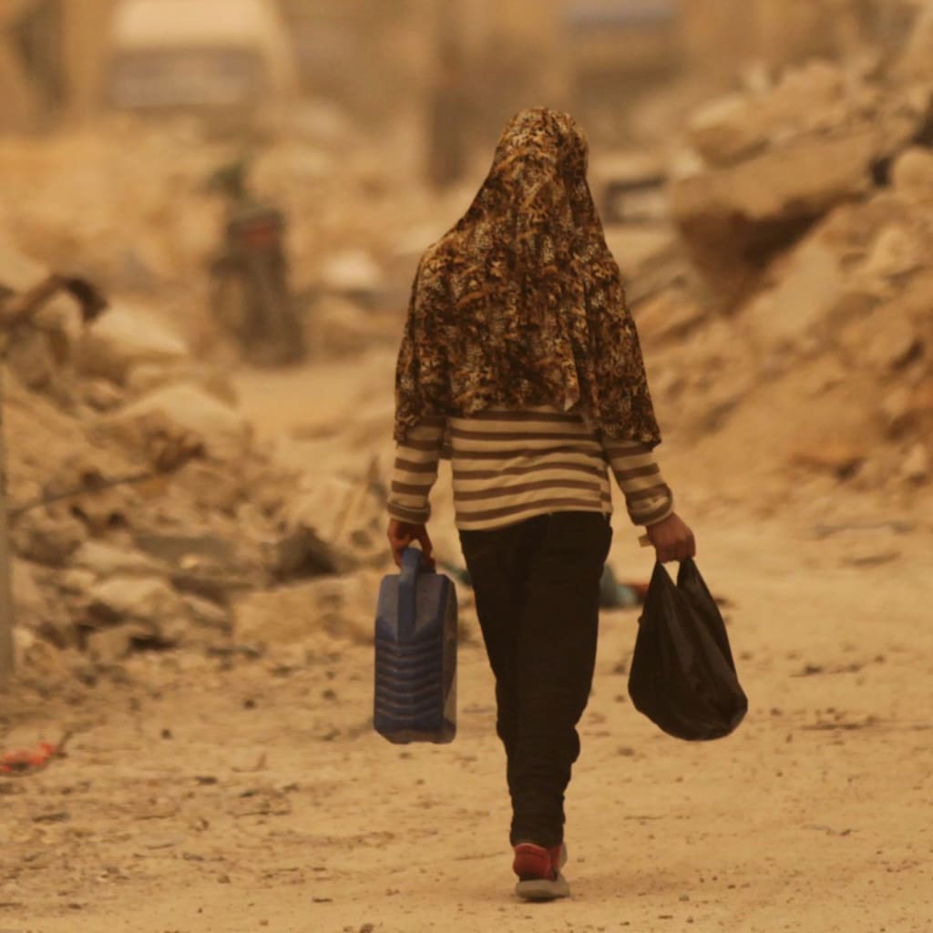 <p>A civilian walks along a street in the northern Syrian town of al-Bab.</p>