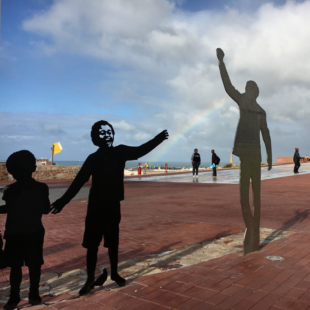 <p>Visitors walk past a metal sculpture of former President Nelson Mandela in Port Elizabeth, South Africa, ahead of local government elections, July 29, 2016. Picture taken July 29, 2016.</p>
