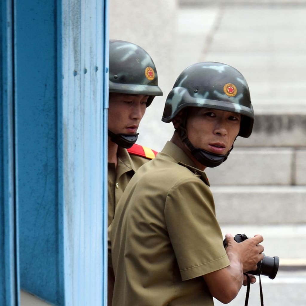 <p>North Korean soldiers at the demilitarized zone dividing the two Koreas.</p>
