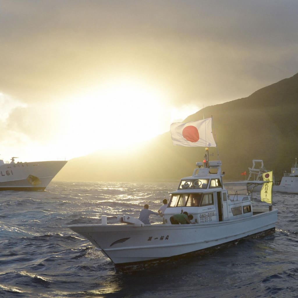 Chinese marine surveillance ship Haijian No. 51 sails near Japan Coast Guard vessels and a Japanese fishing boat in the East China Sea on July 1, 2013.