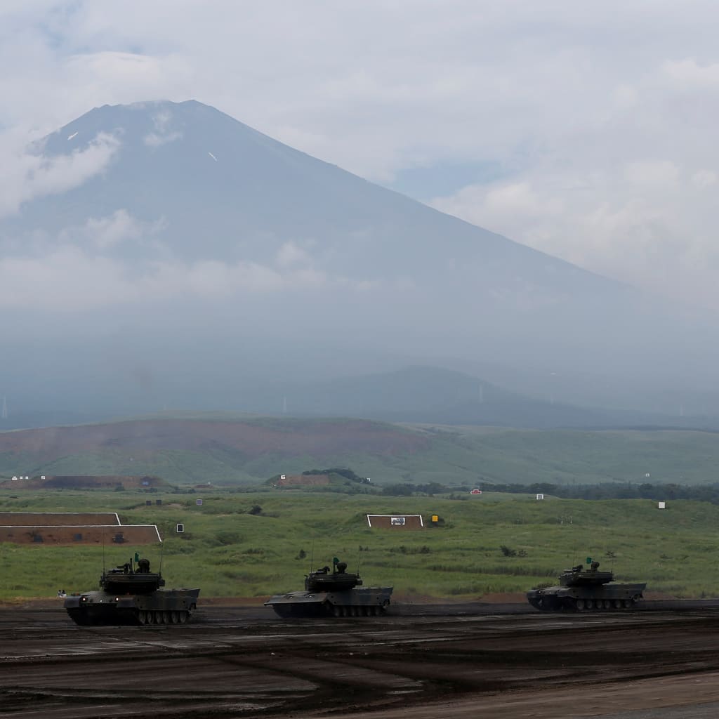 Japanese Ground Self-Defense Force tanks take part in an annual training session with Mount Fuji in the background at Higashifuji training field in Gotemba, west of Tokyo, Japan August 24, 2017