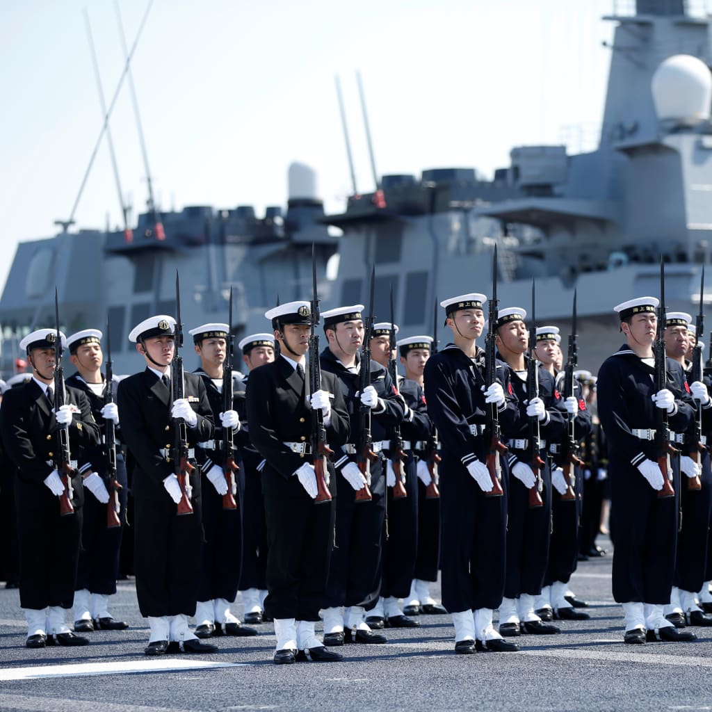 <p>Members of the Japan Maritime Self-Defense Force (JMSDF) attend a handover ceremony for the JMSDF latest Izumo-class helicopter carrier DDH-184 Kaga by Japan Marine United Corporation in Yokohama, Japan on March 22, 2017. </p>
