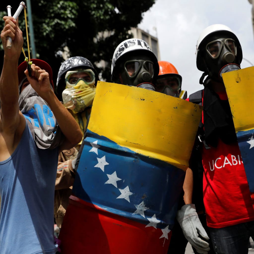 <p>Venezuelan demonstrators clash with riot police during anti-Maduro protests in Caracas, Venezuela on May 24, 2017.</p>
