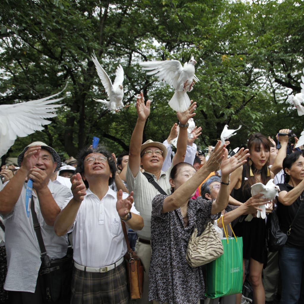 <p>People release doves as a symbol of peace at the Yasukuni Shrine for the war dead in Tokyo August 15, 2012, on the anniversary of Japan’s surrender in World War II.</p>
