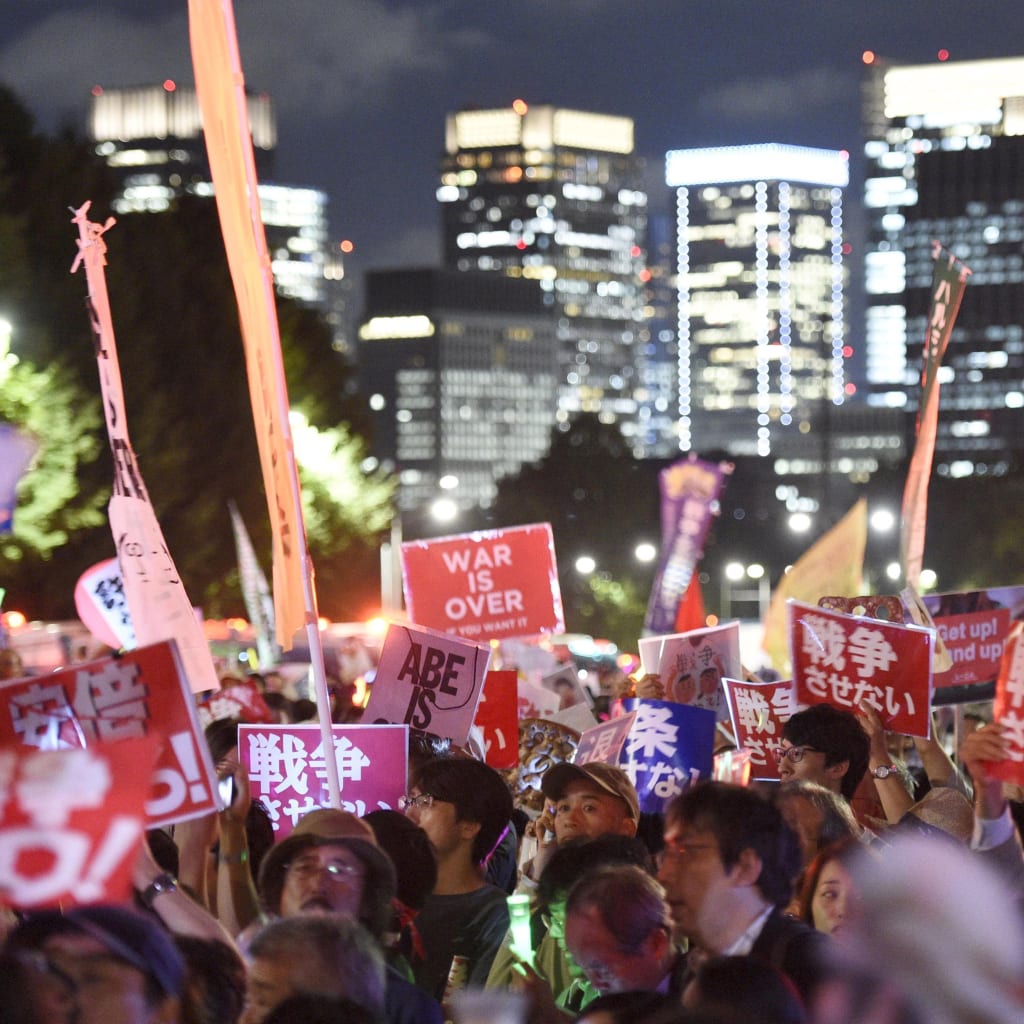 Protesters gather at a rally against Japan's Prime Minister Shinzo Abe's security bill and his administration in front of the parliament building in Tokyo on September 14, 2015.