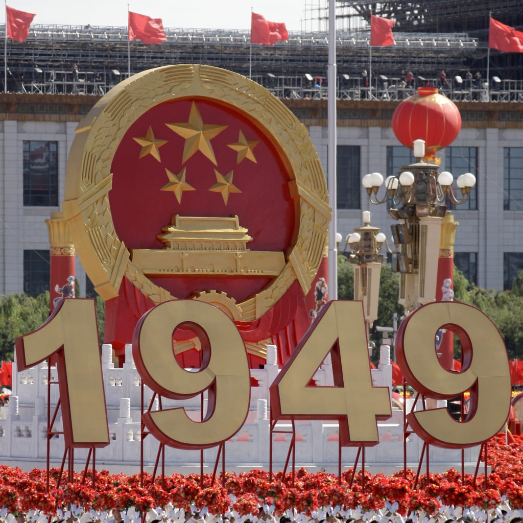 <p>Participants with huge ‘1949’ sign march past Tiananmen Square in a massive parade to mark the 60th anniversary of the founding of the People’s Republic of China in Beijing October 1, 2009.</p>
