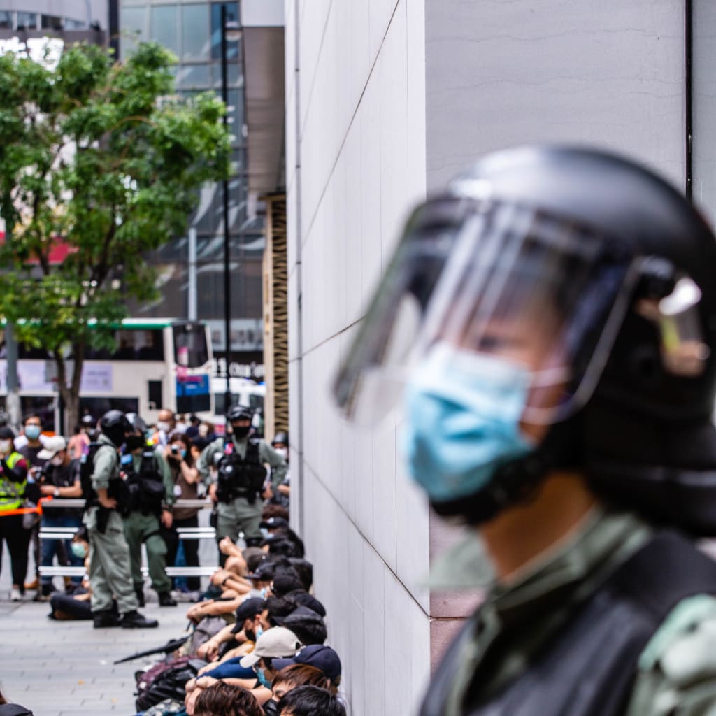 Riot police round up a group of protesters during the