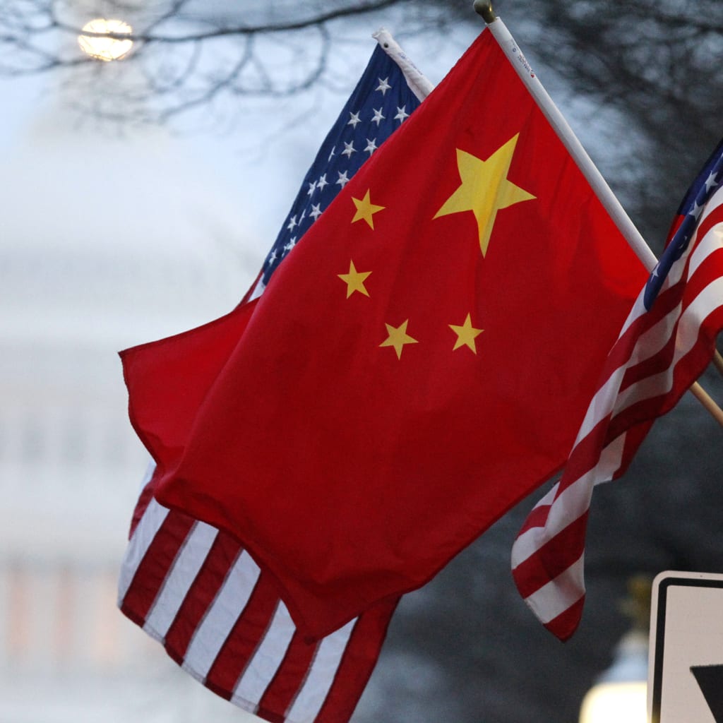 The People's Republic of China flag and the U.S. Stars and Stripes fly along Pennsylvania Avenue near the U.S. Capitol in Washington