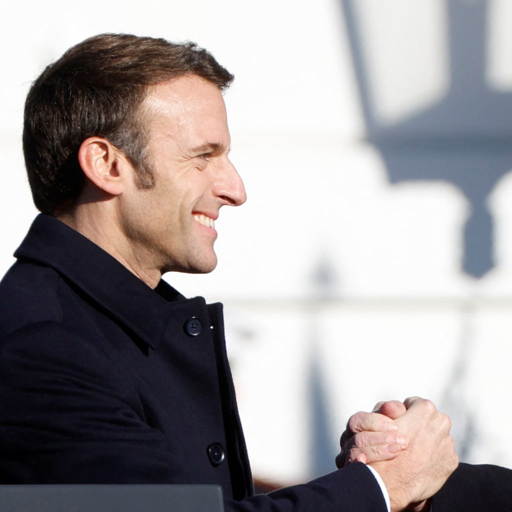 French President Emmanuel Macron greets U.S. President Joe Biden