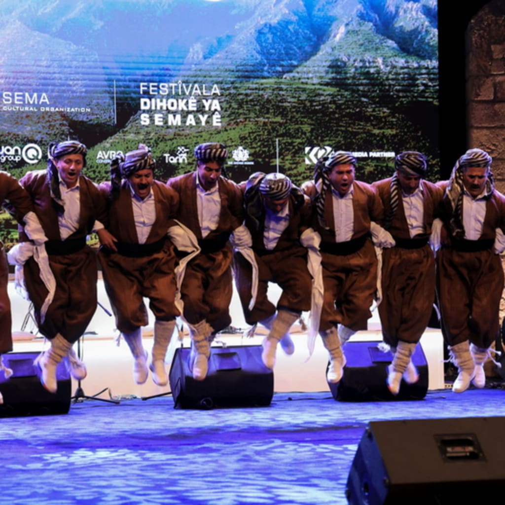 <p>Kurdish men in traditional folklore costumes perform during the Duhok Dance Festival in Duhok Province, Iraq. April 29, 2024.</p>
