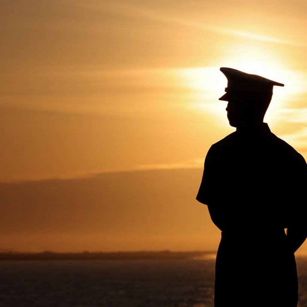 marine looking at coastal sunset
