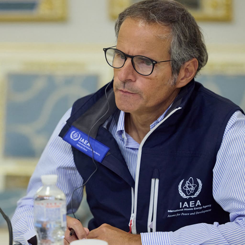 Rafael Mariano Grossi sitting by mic