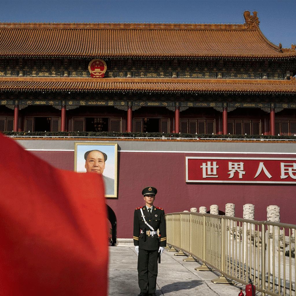 Chinese soldier stands in front of the gates to the Forbidden City in Beijing, China