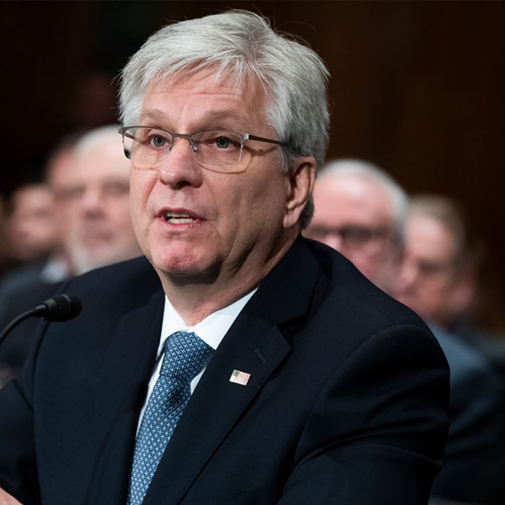 Christopher J. Waller at Congressional hearing in suit