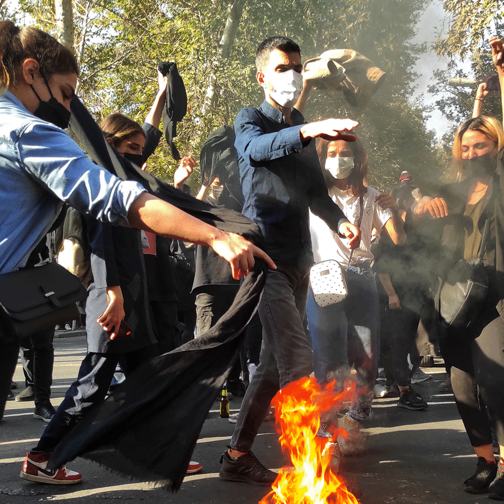 Iranian protestors burning headscarfs