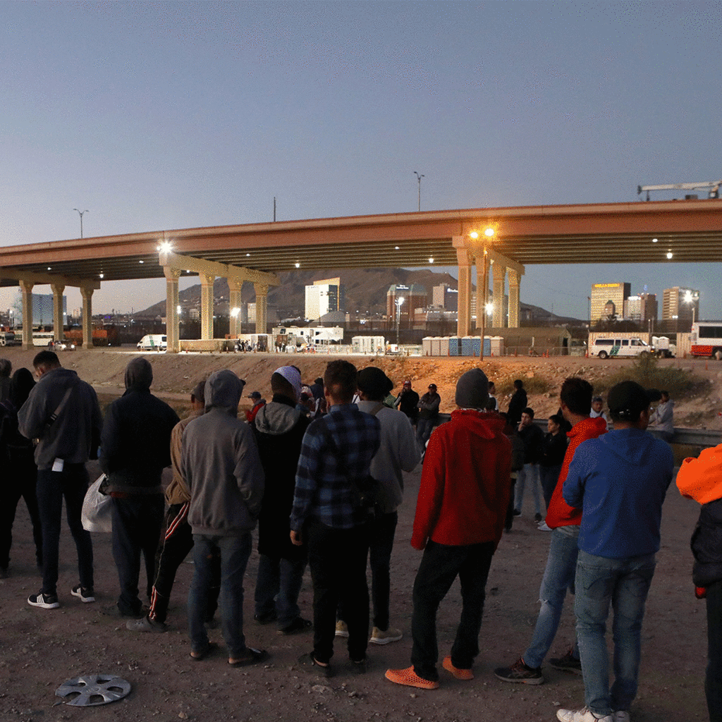 Venezuelan migrants stand in front of the US Border Patrol operations