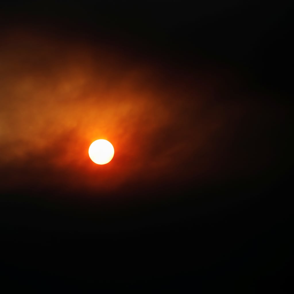 <p>The sun seen through smoke during the Hermits Peak and Calf Canyon fires near Ocate, New Mexico, U.S., May 11, 2022</p>
