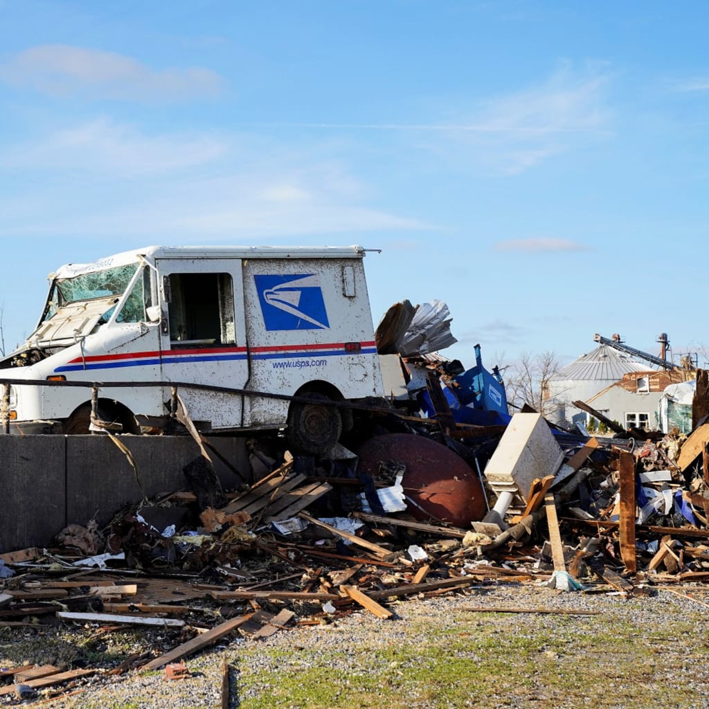 <p>A USPS mail truck is seen badly damaged after a devastating outbreak of tornadoes ripped through several U.S. states, in Mayfield, Kentucky, U.S. December 11, 2021.</p>
