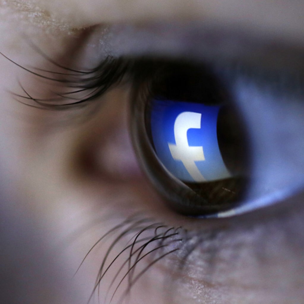 <p>A picture illustration shows a Facebook logo reflected in a person’s eye.</p>
