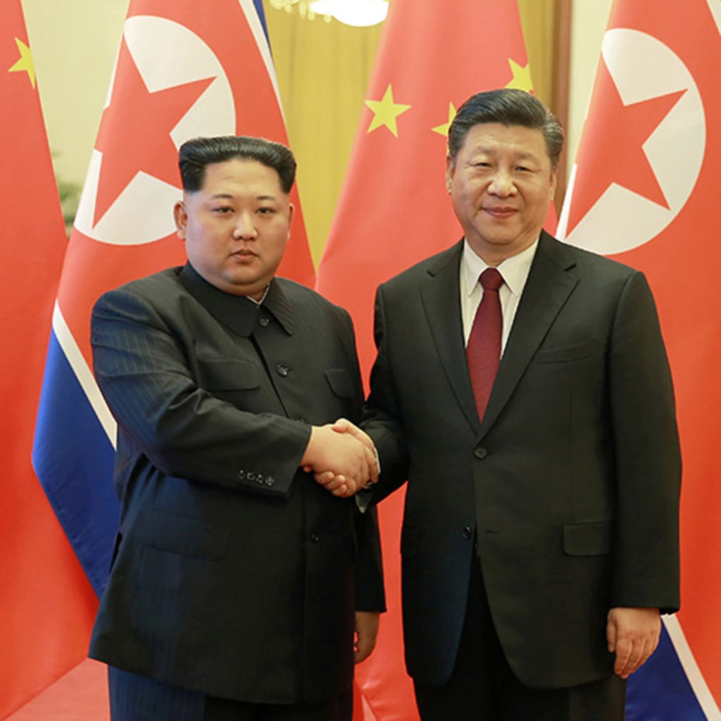 North Korean leader Kim Jong Un shakes hands with Chinese President Xi Jinping