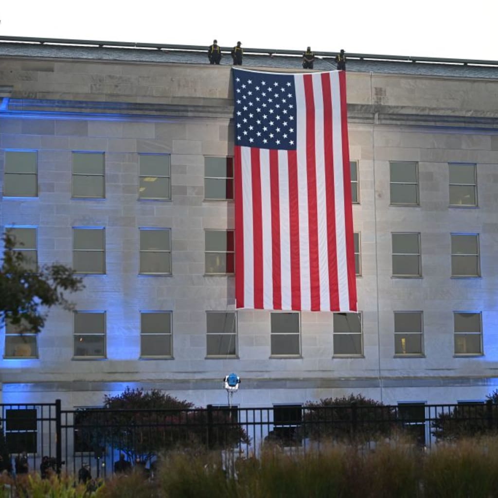 <p>An American flag hangs from the side of the Pentagon to commemorate the 20th anniversary of the 9/11 attacks, on September 11, 2021, in Washington, DC.</p>
