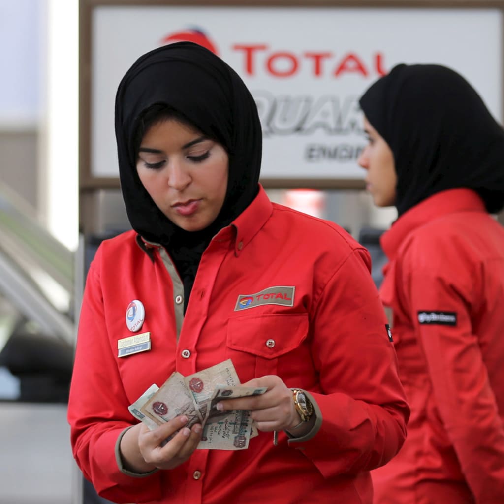<p>A female employee works at a petrol station in Cairo, Egypt. February 24, 2016. </p>
