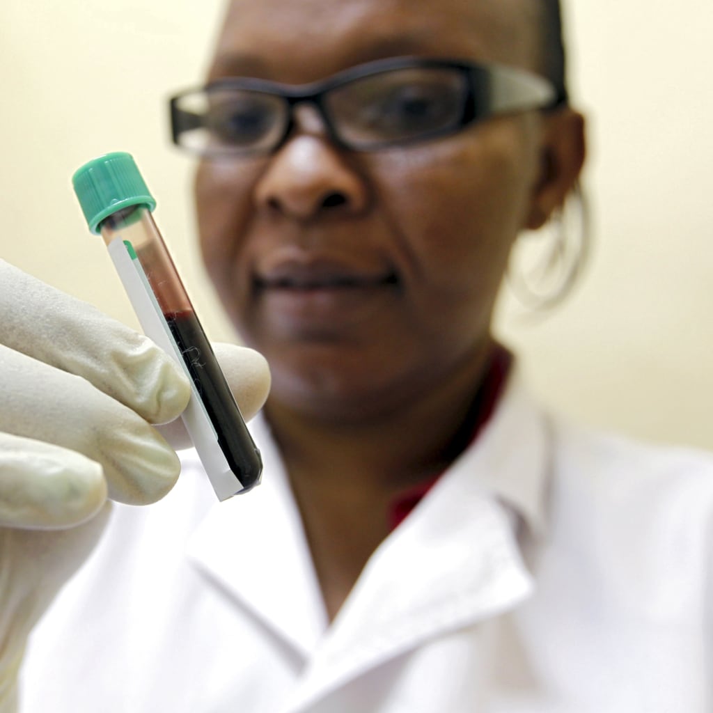 <p>Mishi Mohammed, a phlebotomist, holds a blood sample from a woman to test for HIV at the Mater Hospital in Kenya, September 10, 2015. </p>
