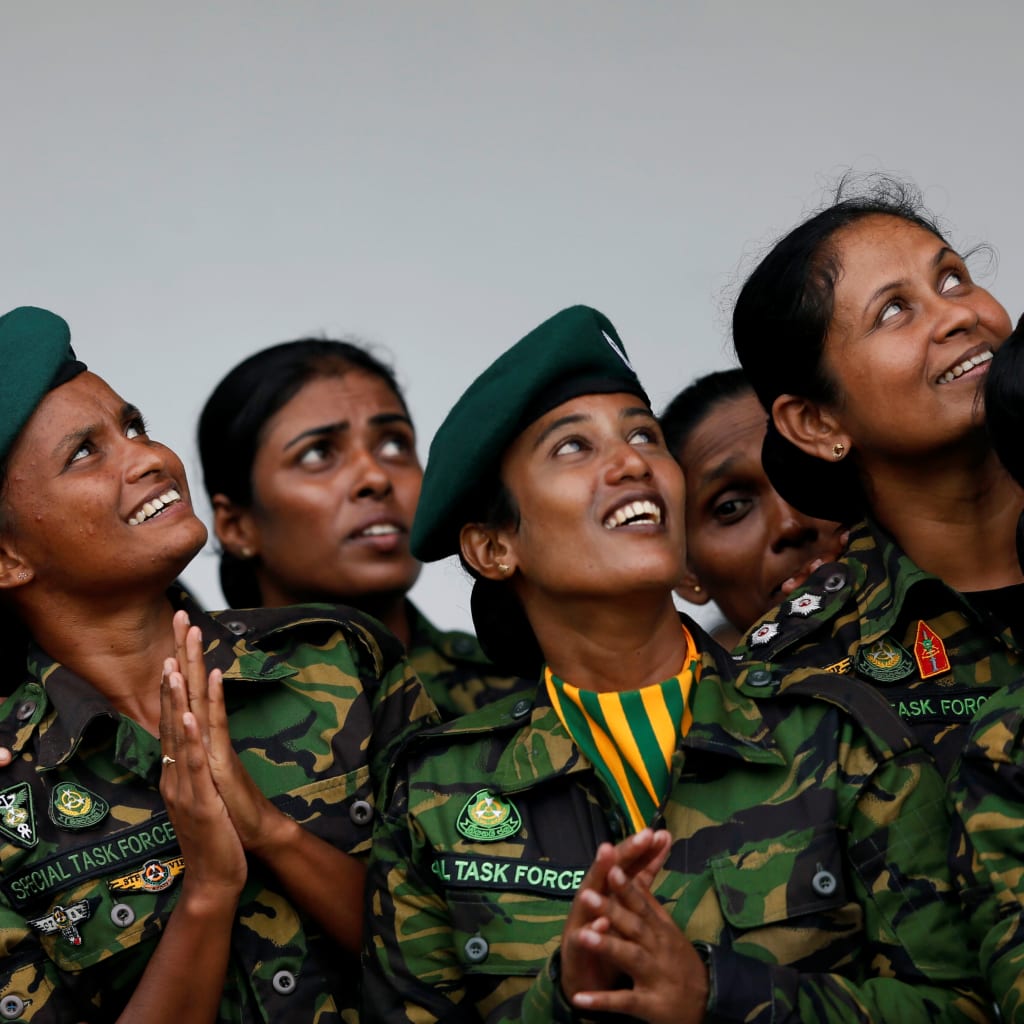 <p>The female Special Task Force (STF) members looks up as they watching the sky divers at a demonstration during the 151st Sri Lanka’s Police anniversary in Colombo, Sri Lanka September 7, 2017.</p>
