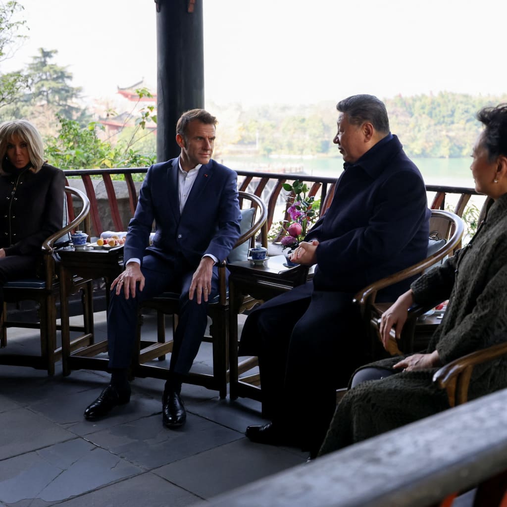 French President Emmanuel Macron, his wife Brigitte Macron, Chinese President Xi Jinping and his wife Peng Liyuan visit the Dujiangyan site, designated a UNESCO World Heritage Site, in Dujiangyan, Sichuan province, as part of a three-day visit to China, December 5, 2025. REUTERS/Sarah Meyssonnier/Pool