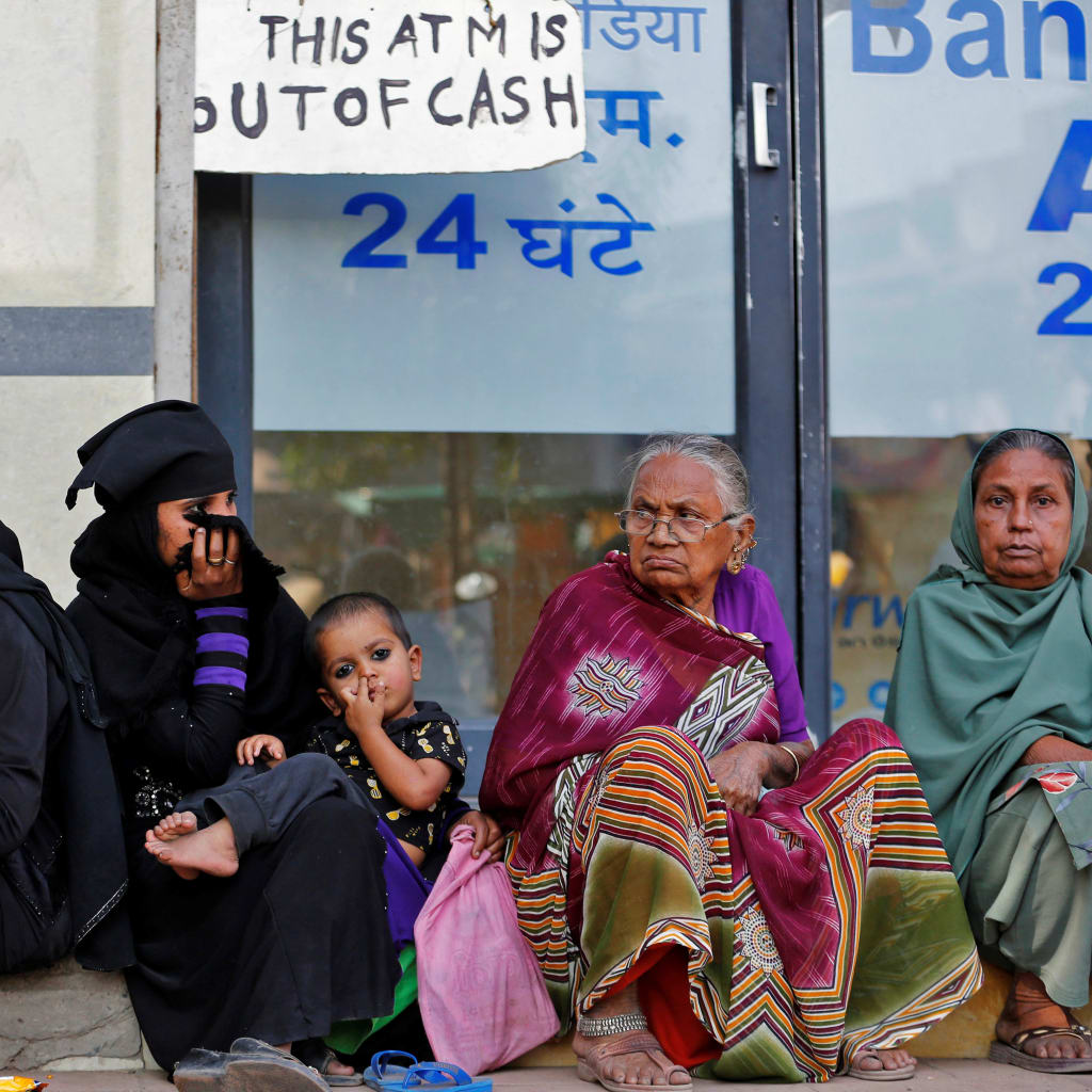 <p>Women sit outside a bank as they wait for their turn to deposit or withdraw cash in Ahmedabad, India, November 29, 2016.</p>
