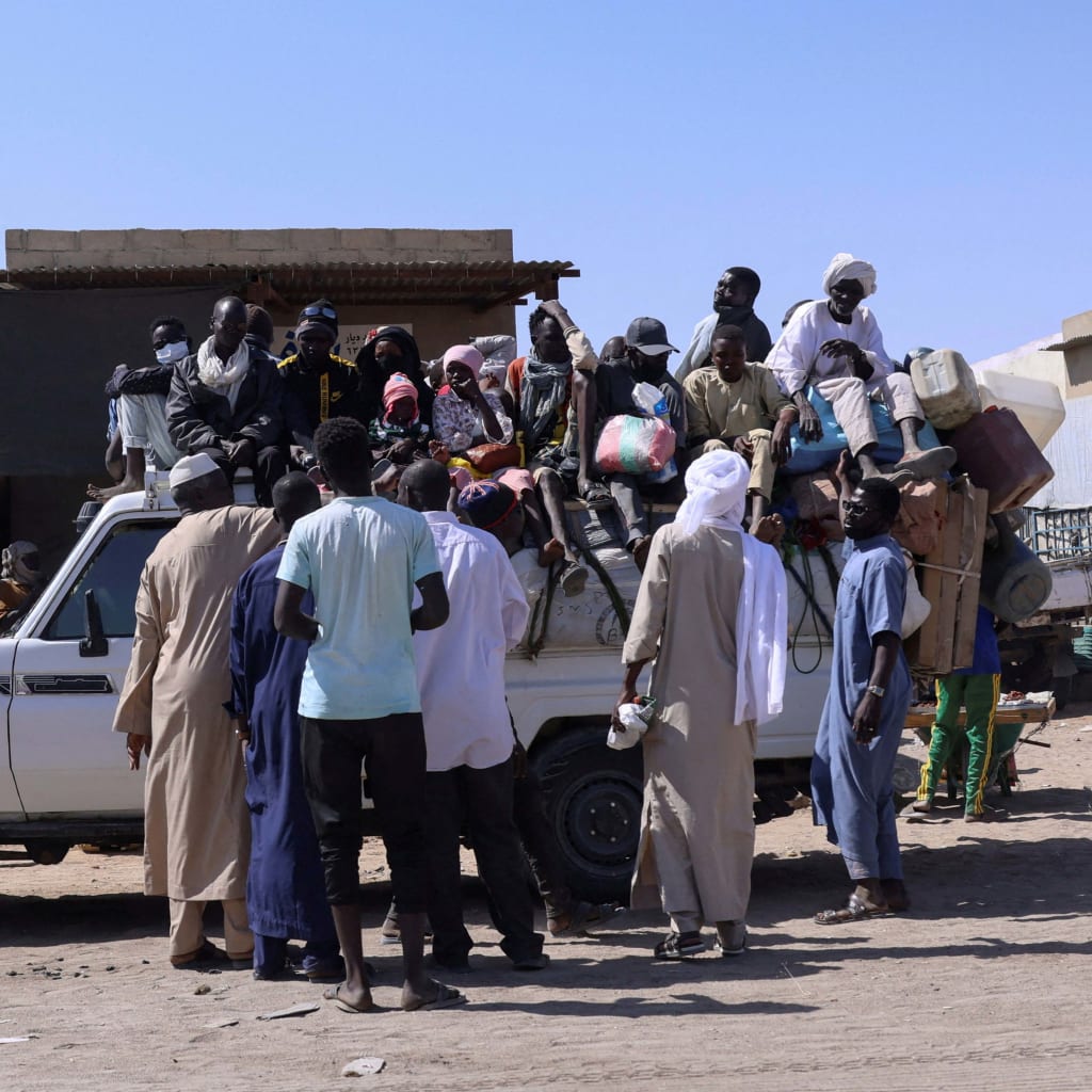 <p>People sit on a pickup truck as they prepare to travel about 250 kilometers south to Adré, on the Chad-Sudan border, at a transport station in Tine, eastern Chad, on November 25, 2025. The movement comes amid the ongoing conflict between the paramilitary Rapid Support Forces and the Sudanese army.</p>
