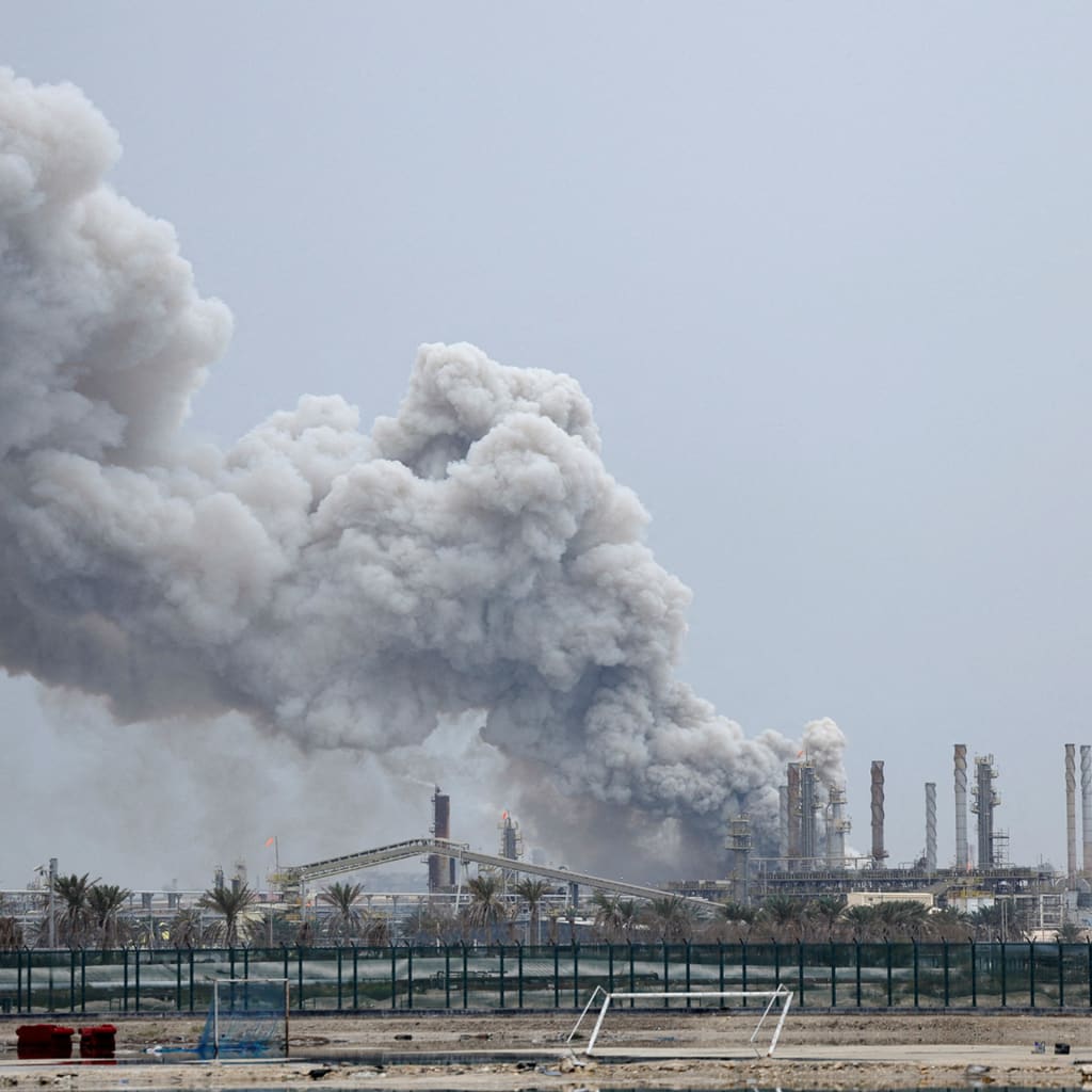 <p>A person rides on a scooter as smoke rises in the Fujairah oil industry zone following a fire caused by debris after interception of a drone by air defenses, in Fujairah, United Arab Emirates, March 3, 2026.</p>
