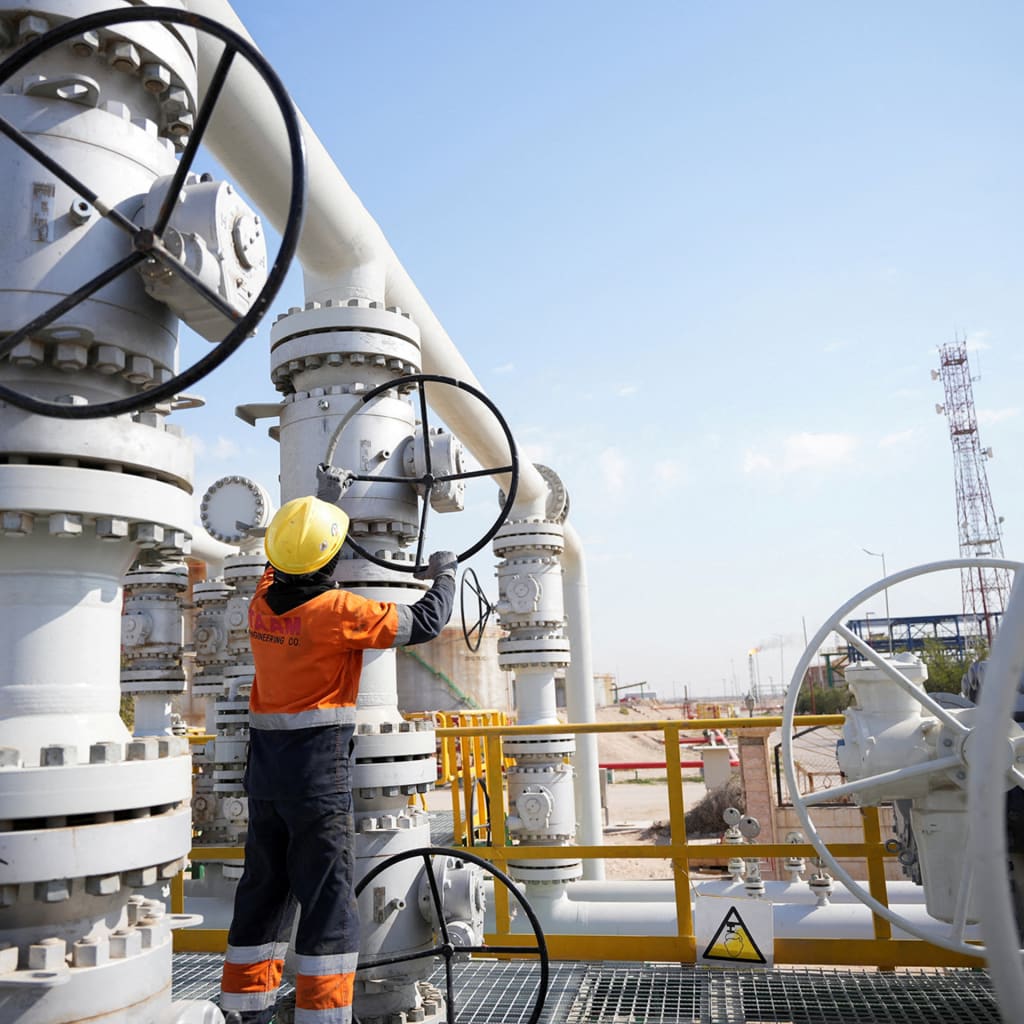 A worker operates valves at the Rumaila oil field, as the country cuts nearly 1.5 million barrels per day of output amid halted exports following the closure of the Strait of Hormuz, in Basra, Iraq, on March 4, 2026. 