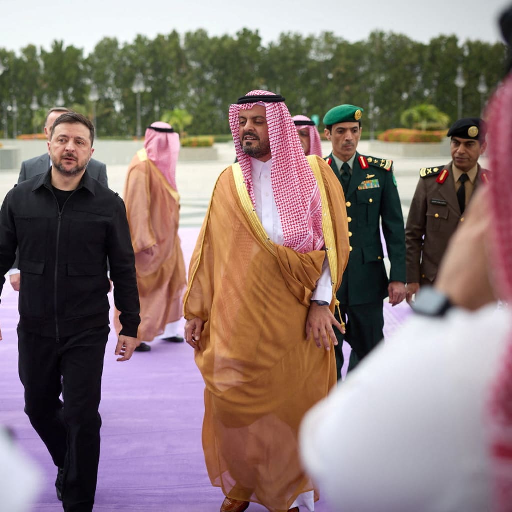 Ukraine's President Volodymyr Zelenskyy walks outdoors with Deputy Governor of Makkah Region Prince Saud bin Mishaal bin Abdulaziz during his visit to Jeddah, Saudi Arabia.
