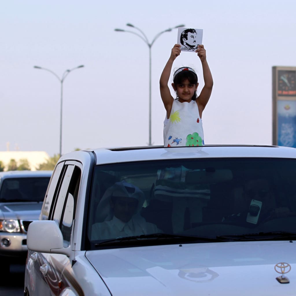 <p>A girl holds a picture depicting Qatar’s Emir Sheikh Tamim Bin Hamad Al-Thani during a demonstration in support of him in Doha, Qatar June 11, 2017.</p>
