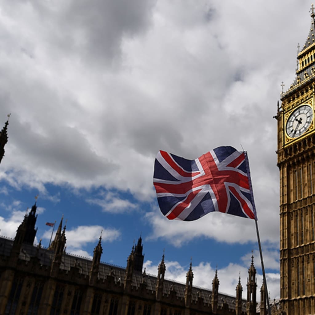 <p>The national flag of the United Kingdom flies near the Houses of Parliament the day before a general election in central London, Britain. </p>
