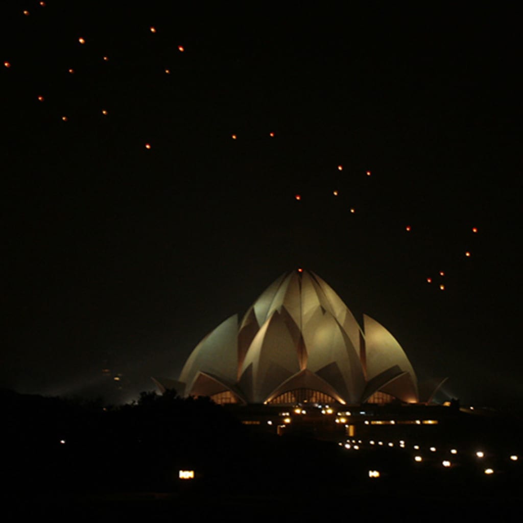 Sky lanterns float over the Lotus Temple in New Delhi