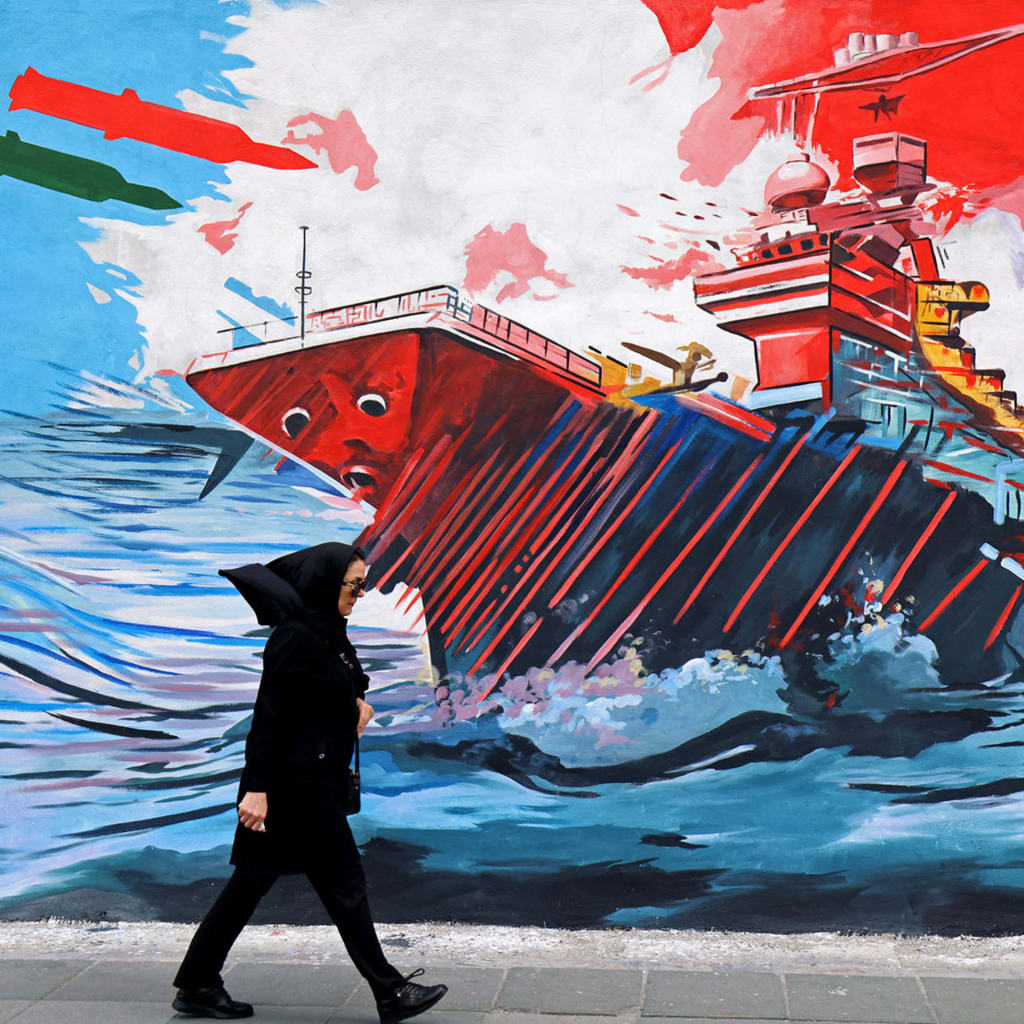 <p>A woman walks past an anti-United States and anti-Israel mural in Tehran on April 8, 2026.</p>
