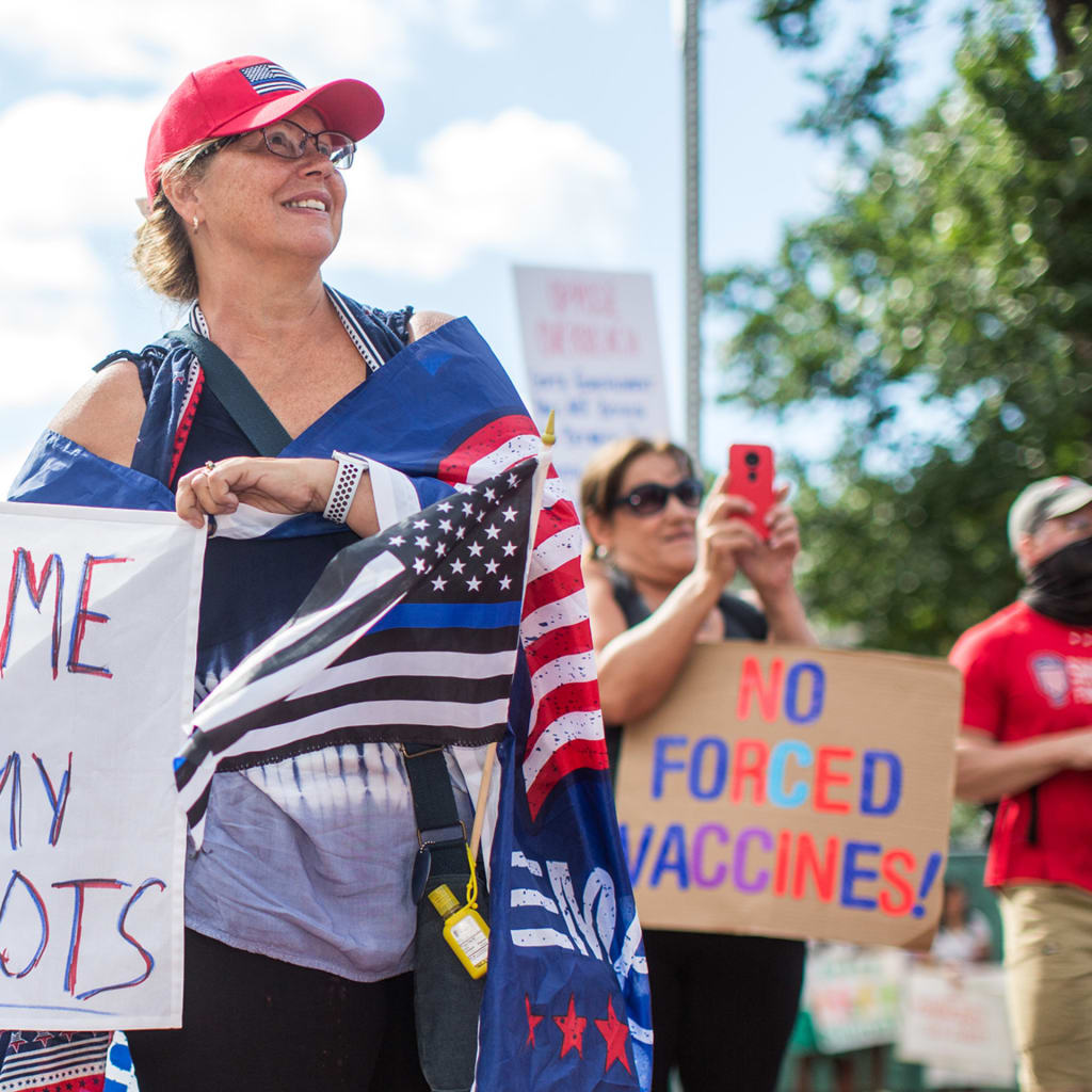 A photo of a woman protesting vaccination mandates