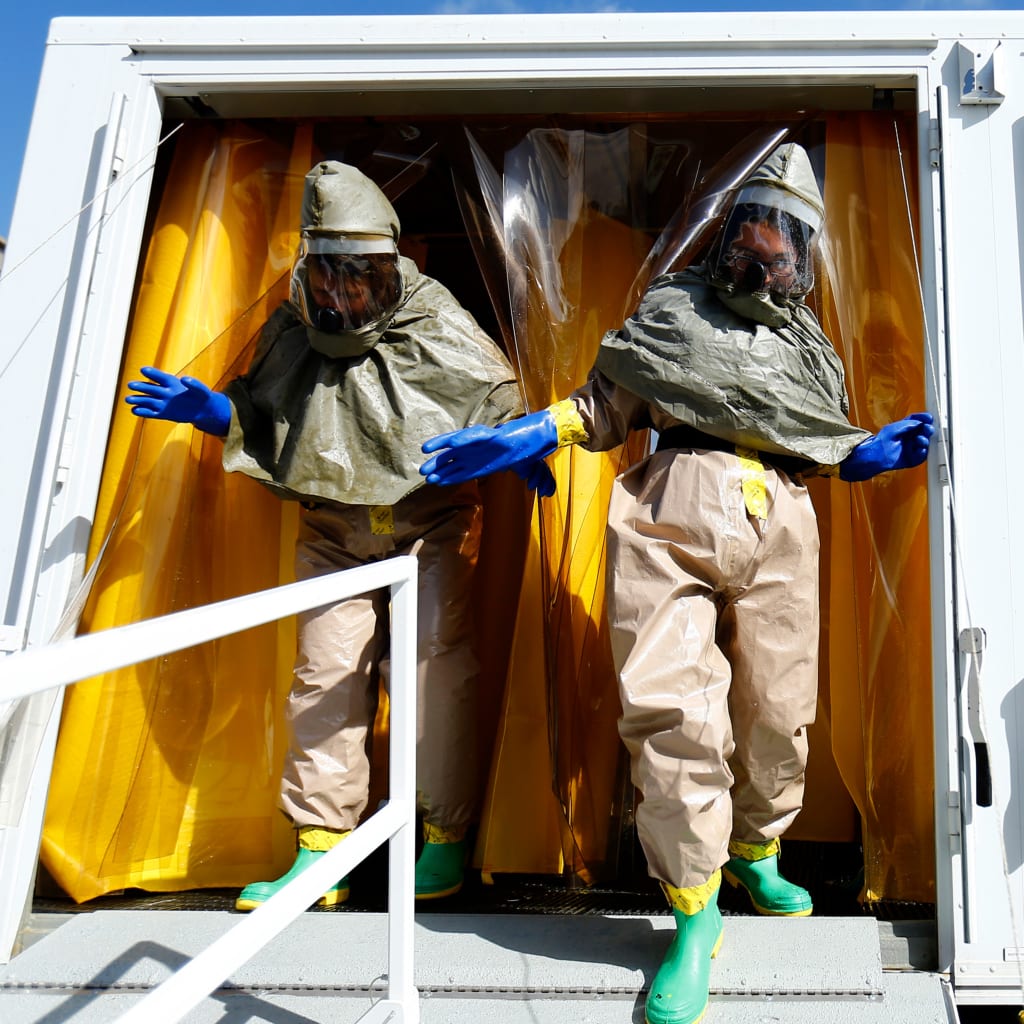 Employees at Palomar Medical Center leave a decontamination trailer during a drill outside their hospital in Escondido, California