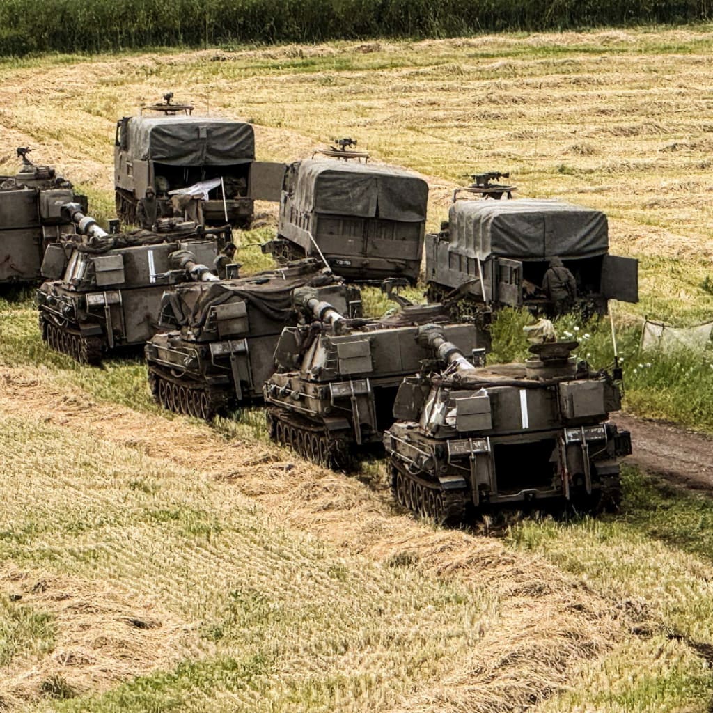Israeli artillery units and military vehicles in formation on the Israeli side of the Israel-Lebanon border in northern Israel