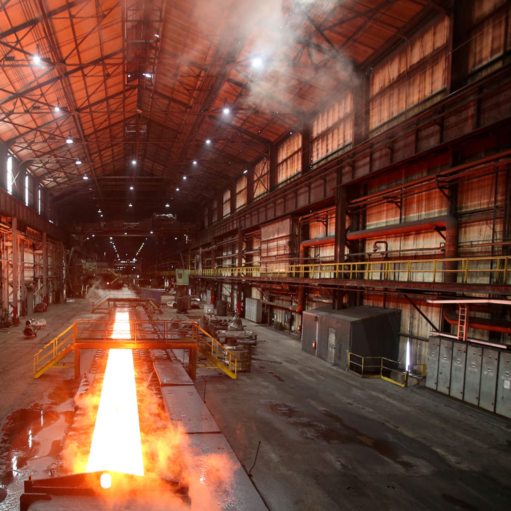Steam rolls off a slab of steel as it rolls down the line at the Novolipetsk Steel PAO steel mill in Farrell, Pennsylvania,